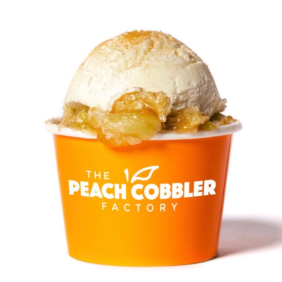 peach cobbler with ice cream in an orange container